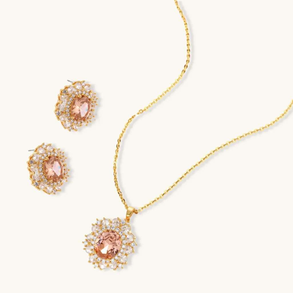 التشكيلات Ornate gold-plated jewelry set featuring peach center stone surrounded by clear AAA cubic zirconia crystals