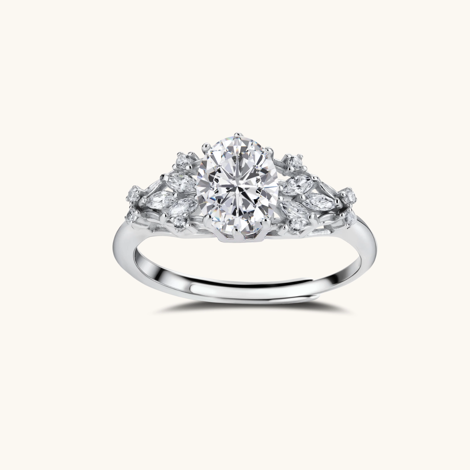 242027068406583296.webp Sterling silver ring with oval moissanite center stone surrounded by smaller accent stones in ornate setting