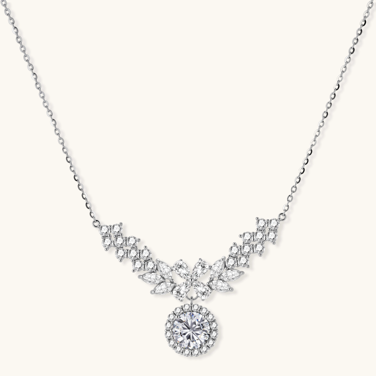 242033275162808320.webp Elegant sterling silver necklace featuring intricate wing-like design with brilliant moissanite stones on neutral background.