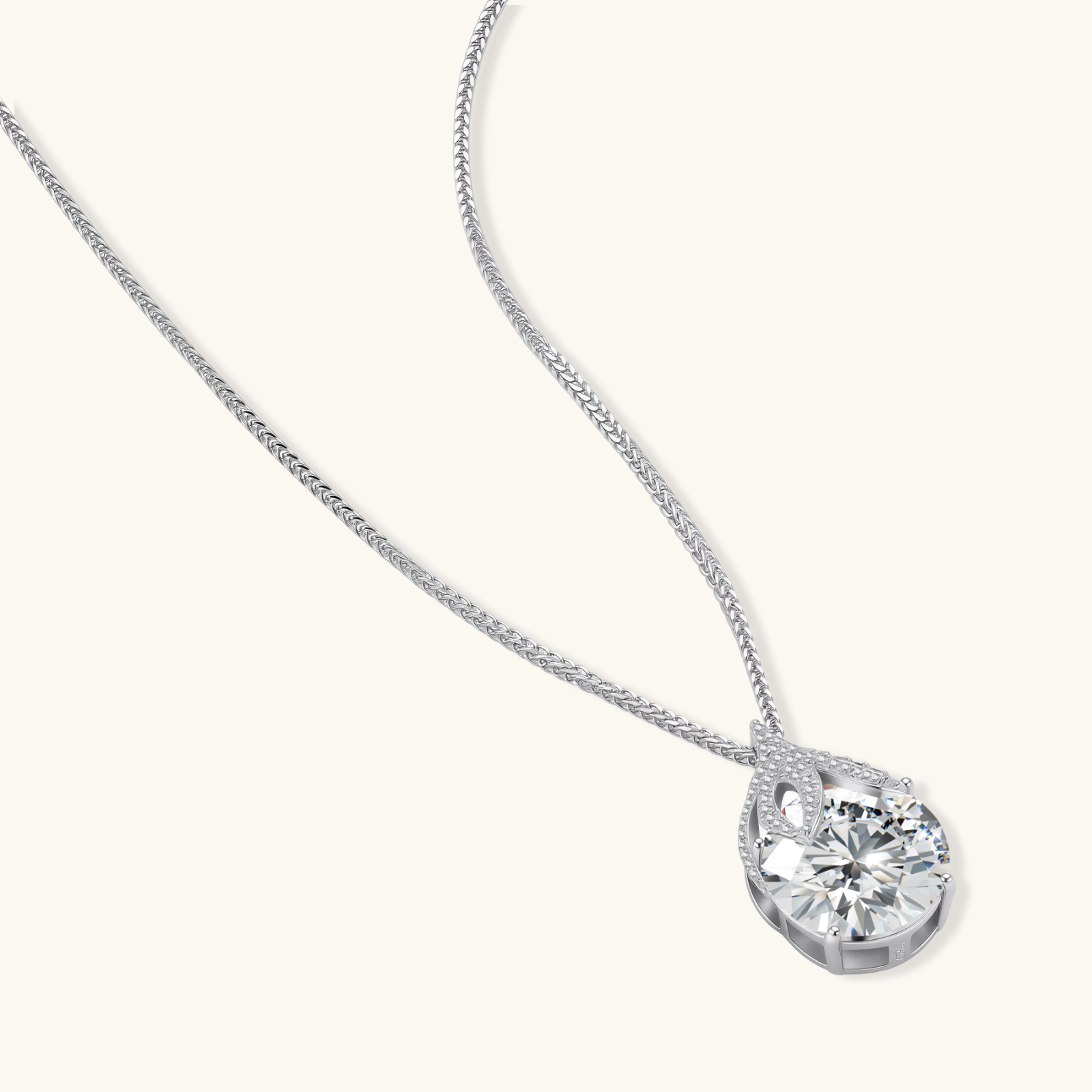 242034936583450624.webp Sterling silver necklace featuring a large pear-shaped moissanite stone in an ornate setting with smaller accent stones