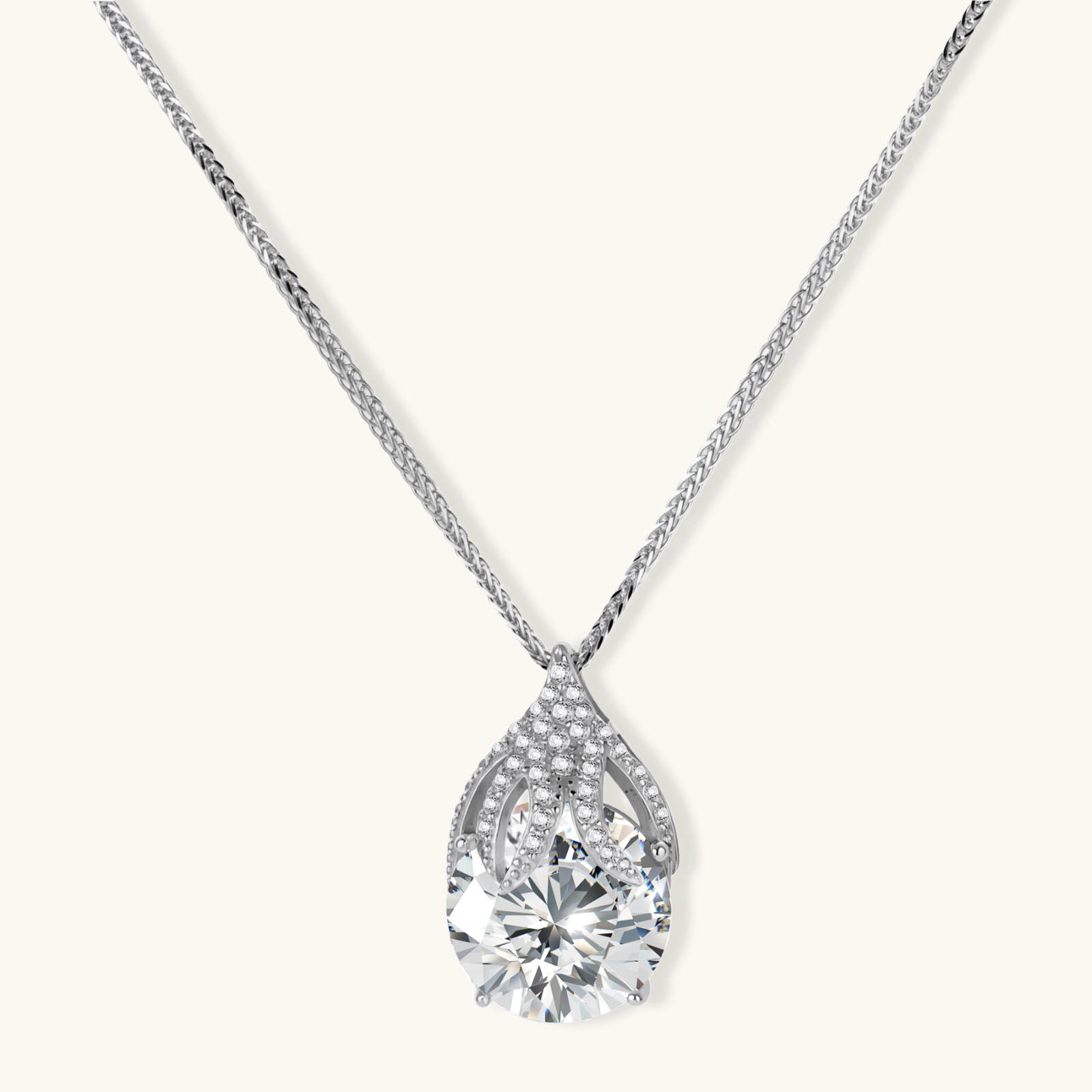 242034936629587968.webp Sterling silver necklace featuring a large pear-shaped moissanite stone in an ornate setting with smaller accent stones