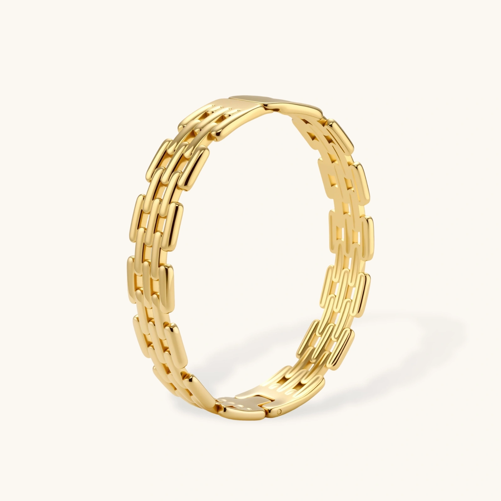 grid link bracelet Wide 18K gold plated stainless steel bracelet with a multi-row rectangular grid link chain pattern on a cream background.